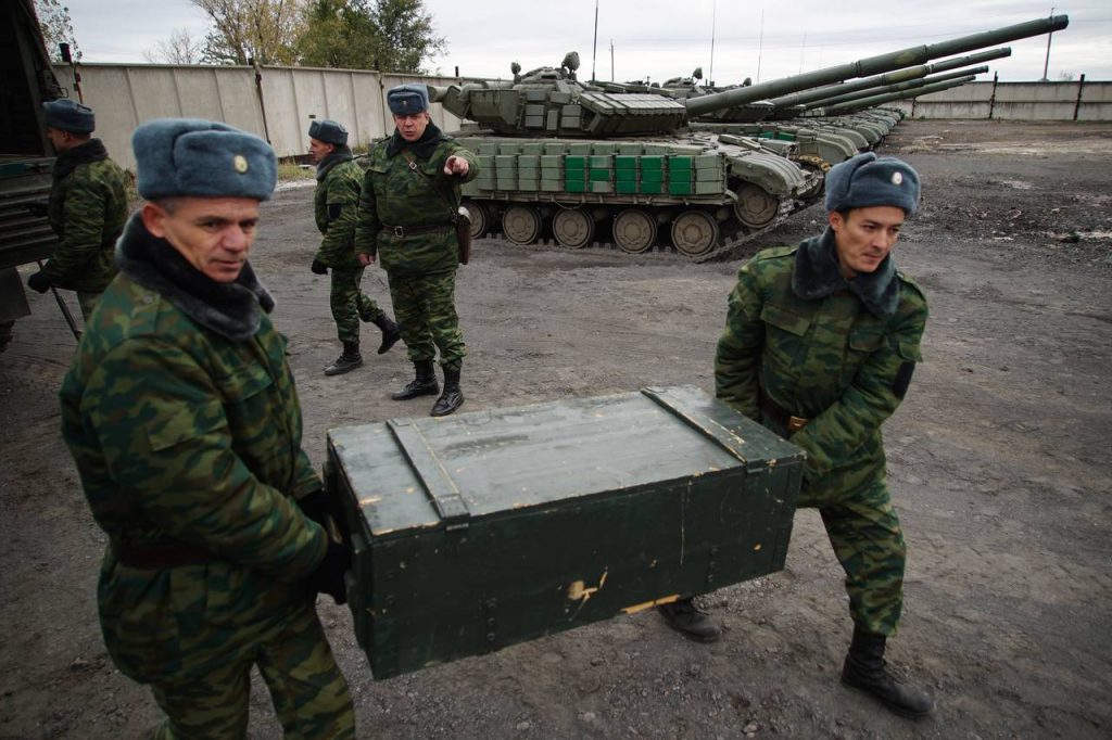 Russia-backed rebels unload mortars from trucks during a pullback of weapons near Luhansk in eastern Ukraine on Oct. 15. U.S. officials said advanced radar systems being shipped to Ukraine to counter artillery strikes by pro-Russia separatists have been modified to prevent them from peering into Russia. PHOTO: MAX BLACK/ASSOCIATED PRESS
